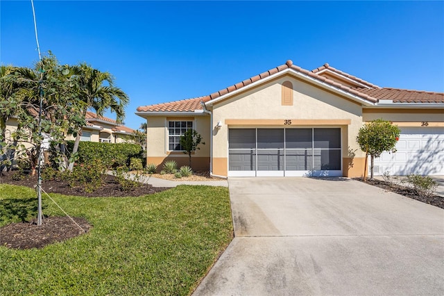 mediterranean / spanish-style house featuring a garage and a front yard