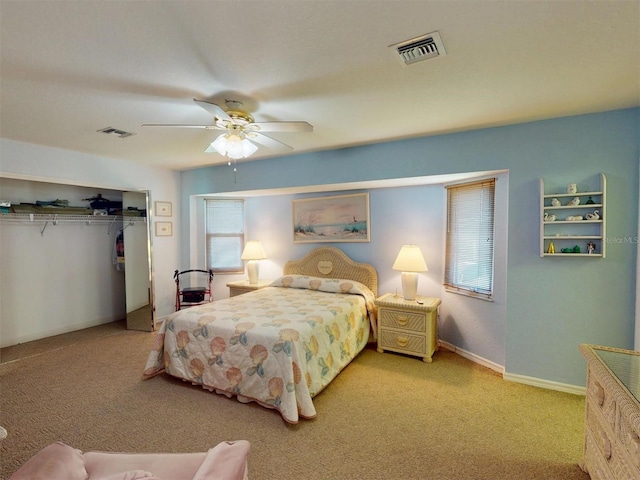 bedroom with light carpet, ceiling fan, and a closet