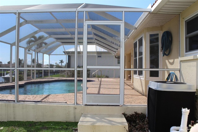 view of swimming pool featuring a patio, a lanai, and central AC unit