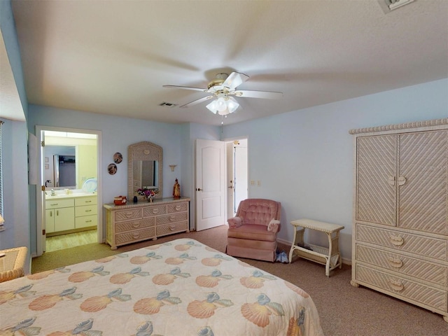 carpeted bedroom with ceiling fan and ensuite bathroom