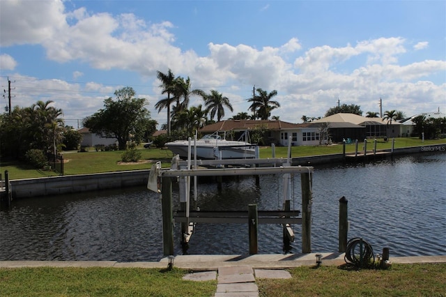 view of dock with a water view and a yard