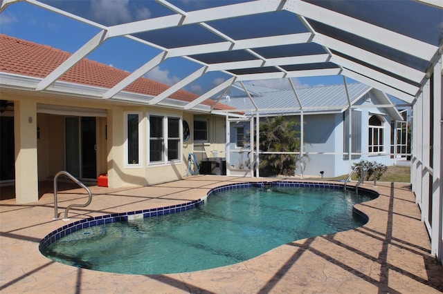 view of pool with a patio and glass enclosure