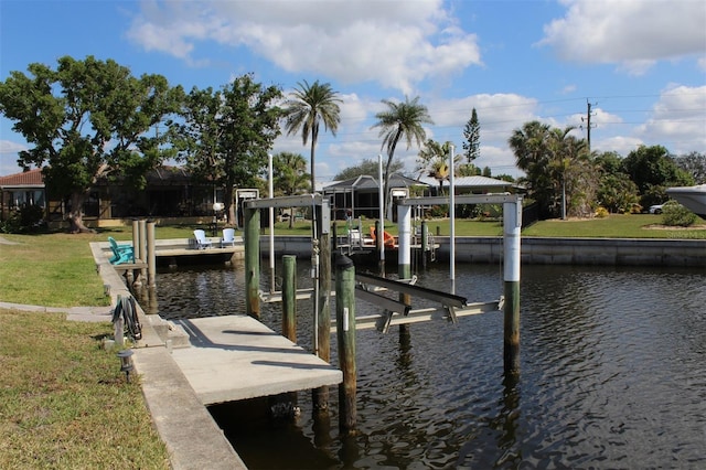 dock area featuring a water view and a lawn