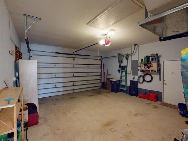 garage with a garage door opener and electric panel