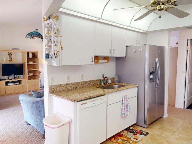 kitchen featuring white cabinetry, dishwasher, sink, ceiling fan, and light stone counters