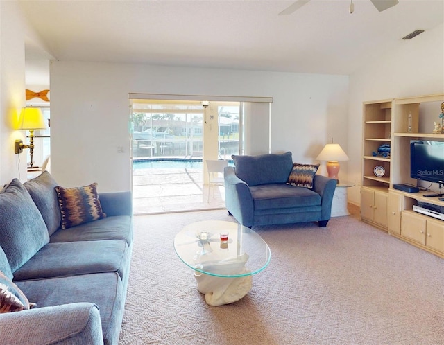 living room featuring ceiling fan and carpet