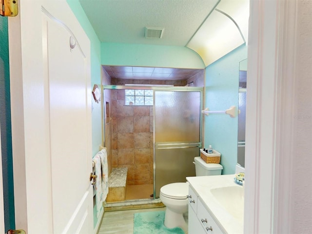 bathroom featuring walk in shower, vanity, toilet, and hardwood / wood-style floors