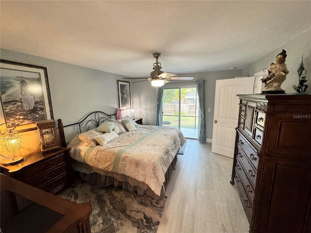 bedroom with ceiling fan, access to outside, a textured ceiling, and light wood-type flooring