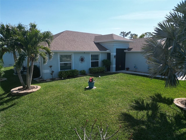 ranch-style home featuring a front lawn