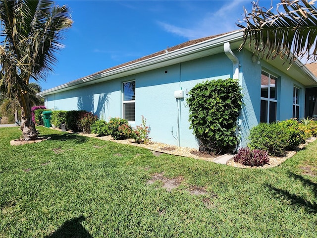 view of property exterior with a yard