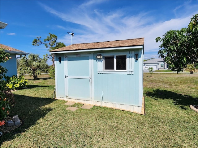 view of outbuilding with a lawn