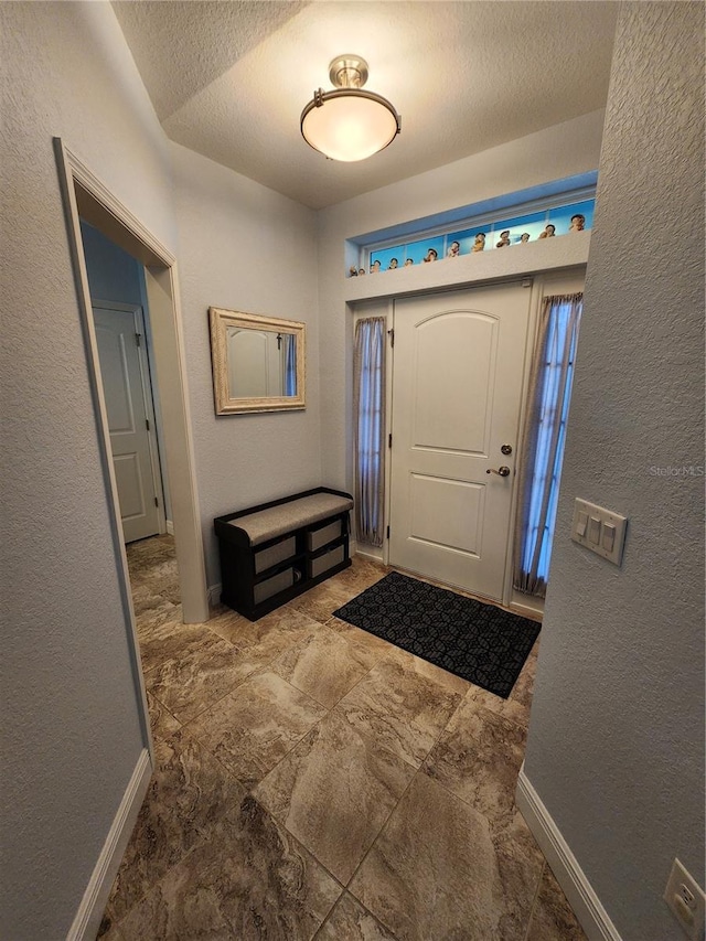 foyer featuring a textured ceiling