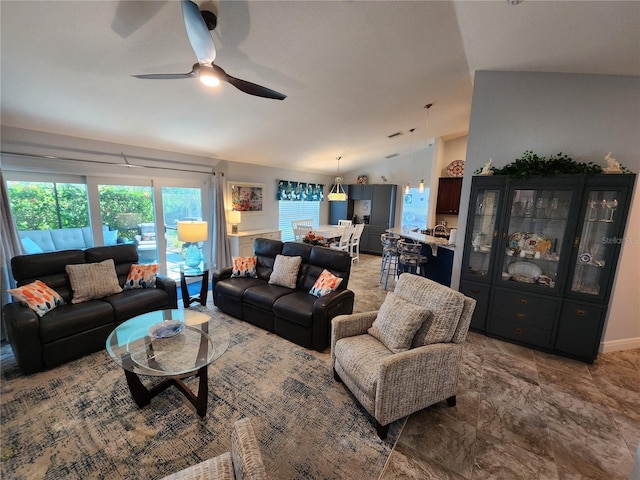 living room featuring ceiling fan and lofted ceiling