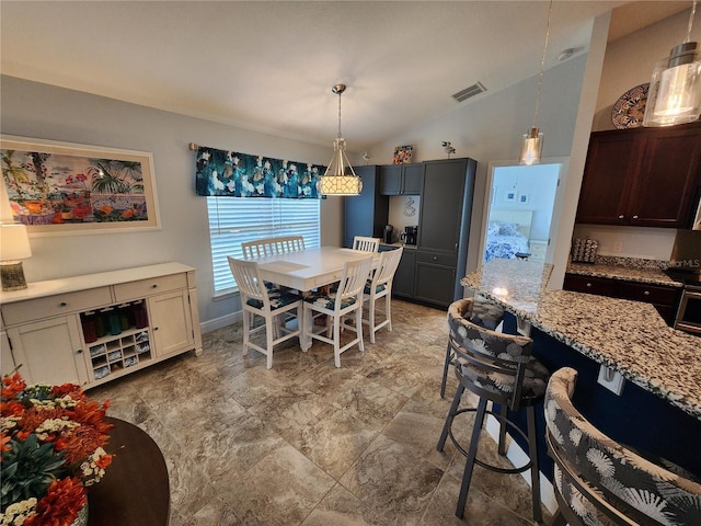 dining space with lofted ceiling