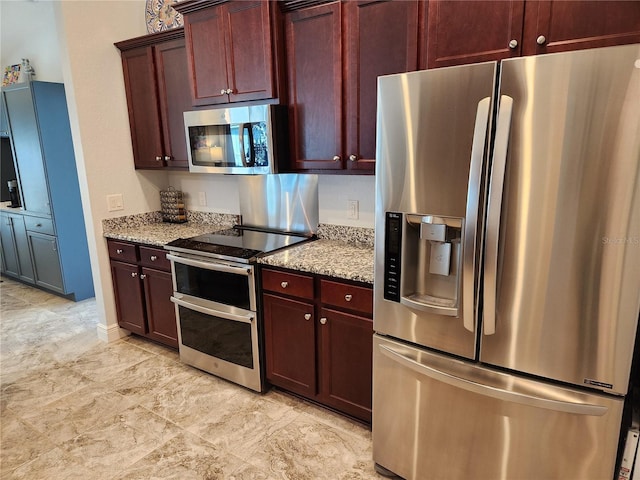 kitchen featuring light stone counters and stainless steel appliances