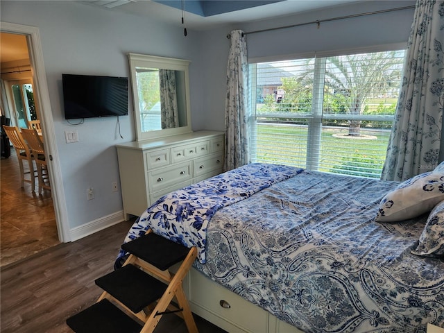 bedroom with dark hardwood / wood-style floors