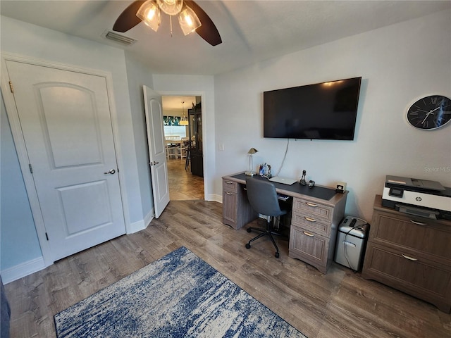 home office with ceiling fan and light hardwood / wood-style floors