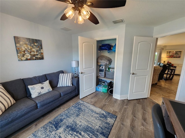 living room with hardwood / wood-style floors and ceiling fan