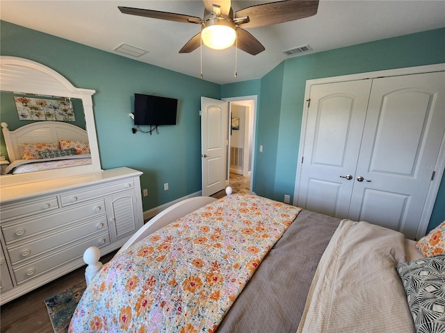 bedroom featuring dark hardwood / wood-style flooring, ceiling fan, and a closet