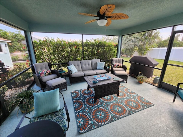 sunroom featuring ceiling fan