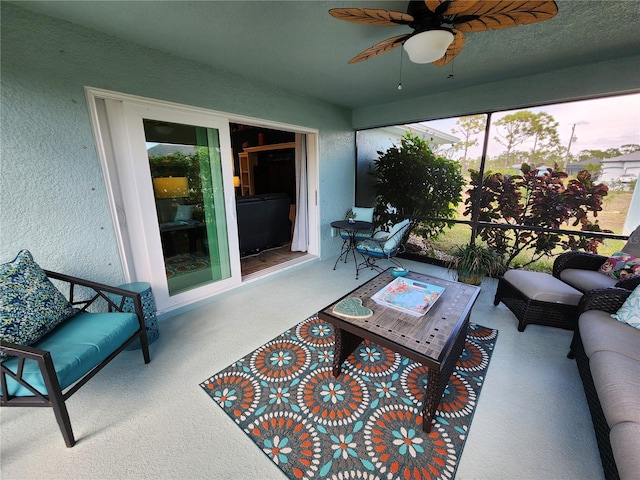 sunroom featuring ceiling fan