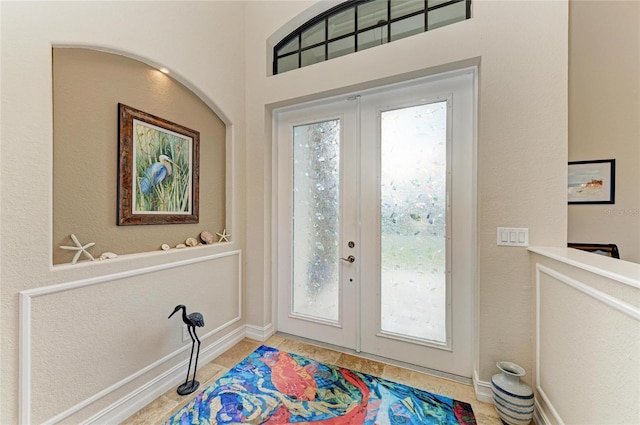 doorway with tile patterned flooring and french doors