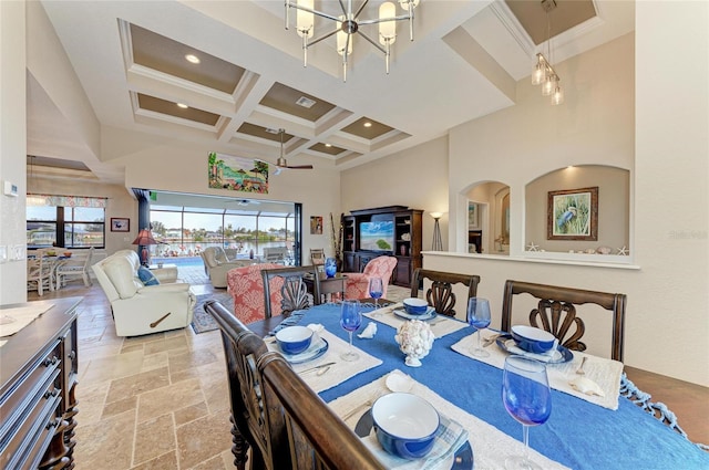 dining area featuring a towering ceiling, beamed ceiling, a chandelier, ornamental molding, and coffered ceiling