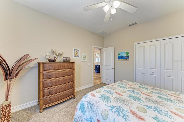 bedroom with ceiling fan, carpet flooring, and a closet