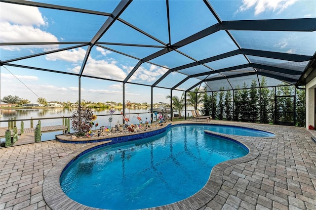 view of pool featuring a patio area, a water view, and glass enclosure