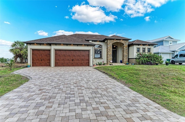 view of front of property featuring a garage and a front lawn