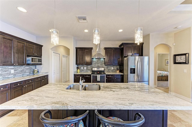 kitchen featuring pendant lighting, sink, a breakfast bar area, and stainless steel appliances