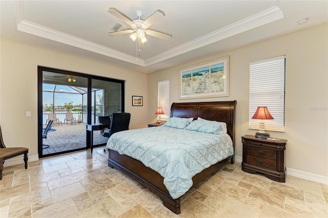 bedroom with a raised ceiling, ornamental molding, and access to outside