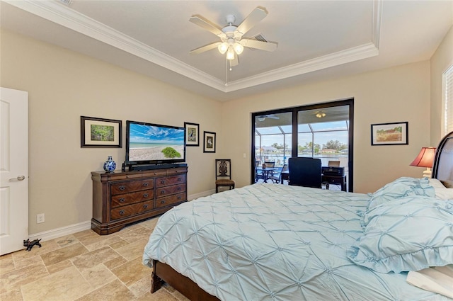 bedroom with access to exterior, a tray ceiling, and ornamental molding