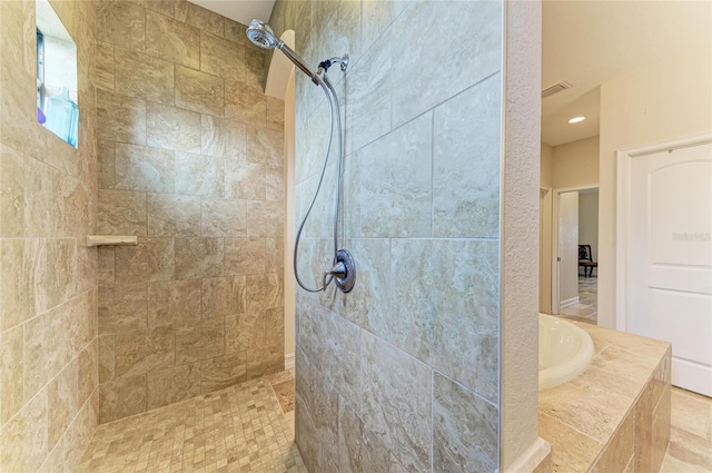 bathroom featuring independent shower and bath