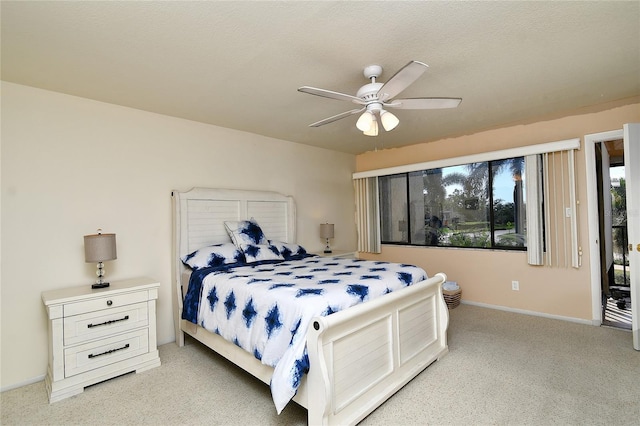 carpeted bedroom featuring a textured ceiling and ceiling fan