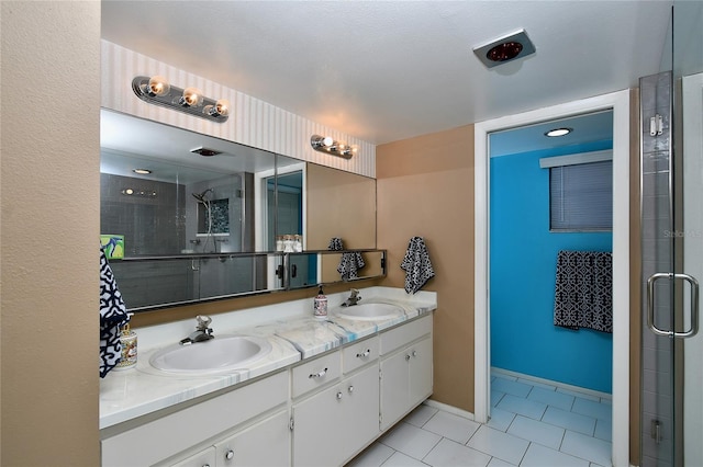 bathroom with vanity, a shower with shower door, and tile patterned flooring