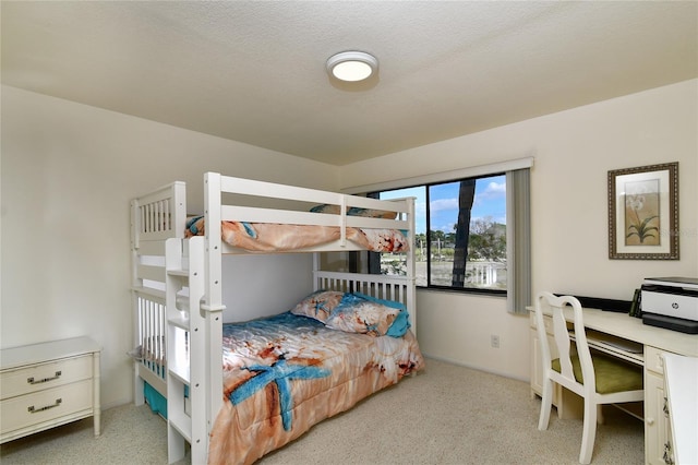 carpeted bedroom featuring a textured ceiling