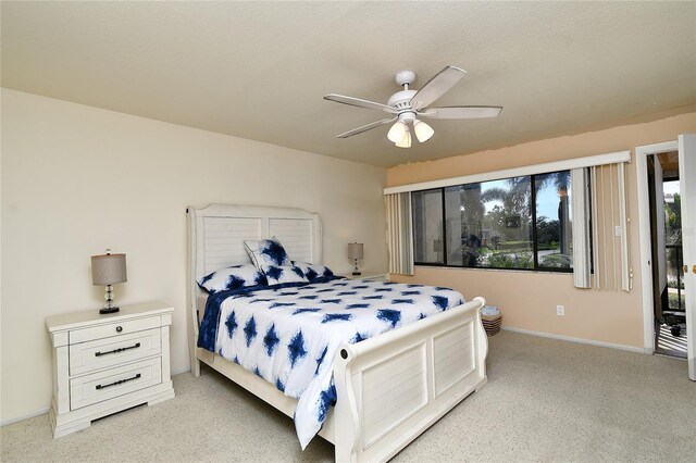 carpeted bedroom featuring a textured ceiling and ceiling fan