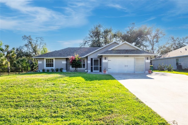 ranch-style home with a garage, cooling unit, and a front lawn