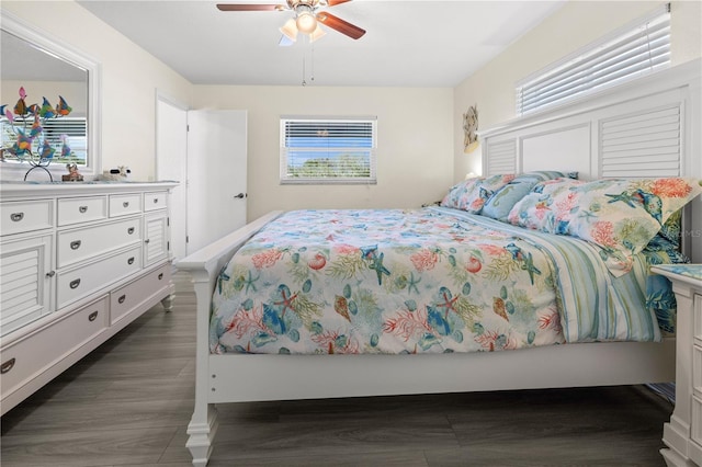 bedroom with ceiling fan and dark hardwood / wood-style flooring