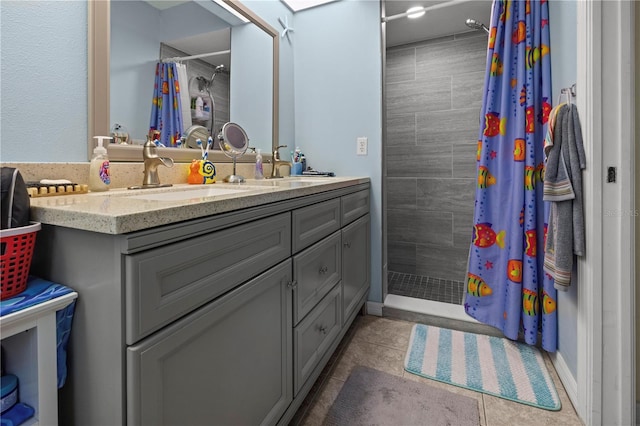 bathroom featuring tile patterned flooring, vanity, and walk in shower