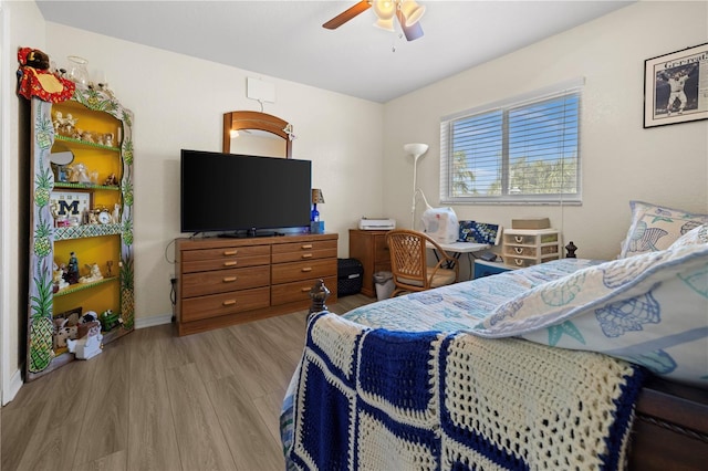 bedroom with ceiling fan and light hardwood / wood-style flooring