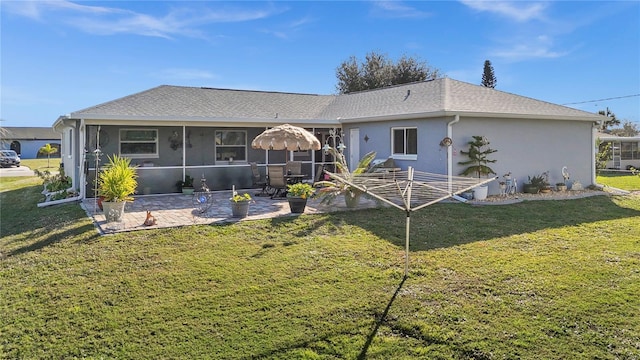 rear view of house featuring a patio area, a sunroom, and a lawn