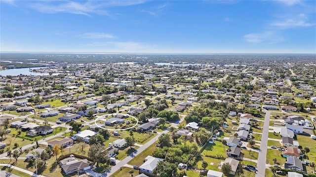 drone / aerial view featuring a residential view and a water view