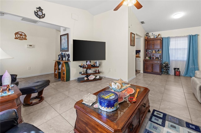 living area featuring lofted ceiling, light tile patterned flooring, visible vents, and ceiling fan