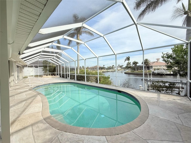 view of swimming pool featuring a water view, a patio, and glass enclosure