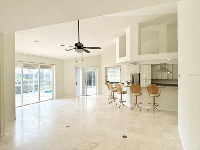 interior space featuring ceiling fan and high vaulted ceiling