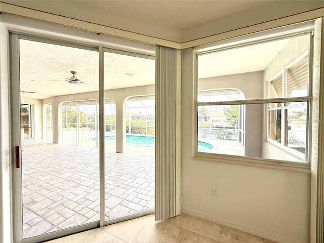 doorway to outside featuring ceiling fan