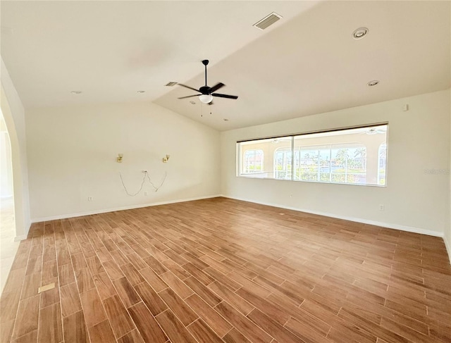 unfurnished living room featuring ceiling fan, lofted ceiling, and wood-type flooring