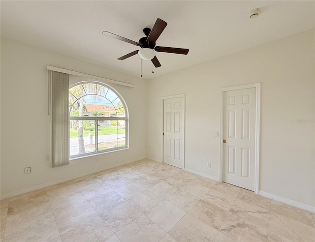 spare room with ceiling fan